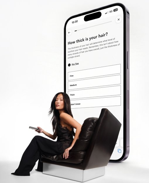 Hair Diagnosis Model seated on a big chair with giant phone